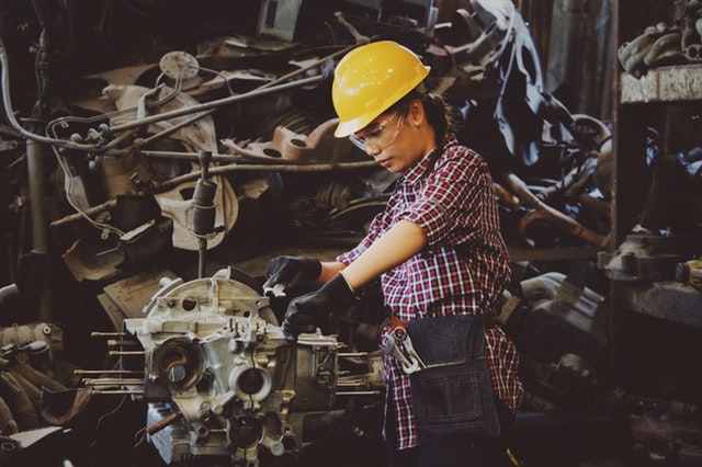 woman-wears-yellow-hard-hat-holding-vehicle-ofw-poea